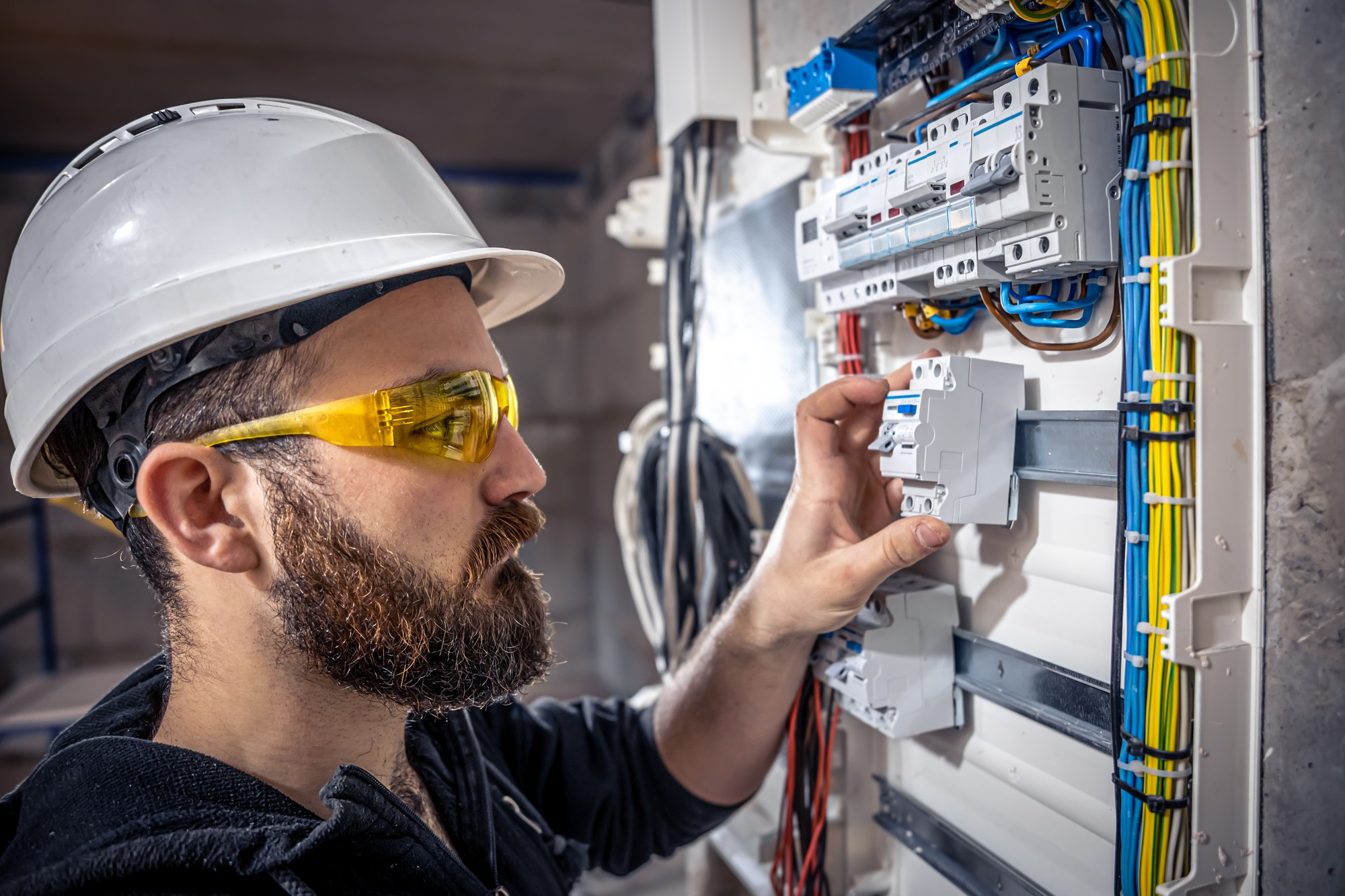 Good Electric electrician inspecting an electrical switchboard