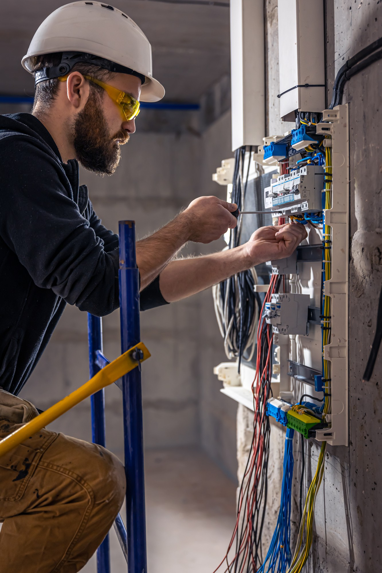 Good Electric technician working on an electrical panel in Vista